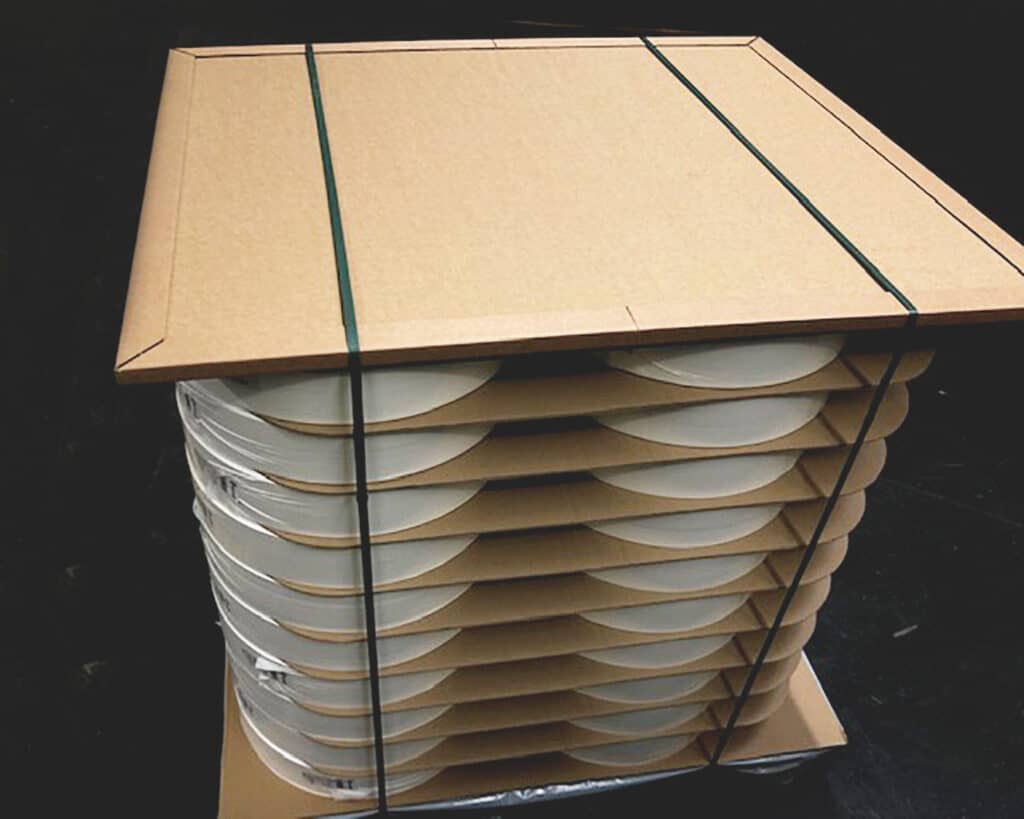 Honeycomb cardboard packaging material on top of goods in pallet.