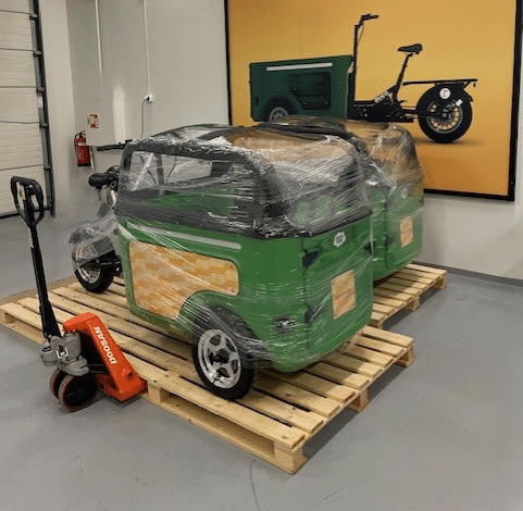 Wrapped green bikes on wooden pallets